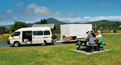 The support vehicle of Green Island Tours with its purpose build trailer at a lunch break in Zeehan